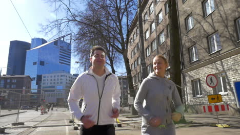 young couple having morning run in the city