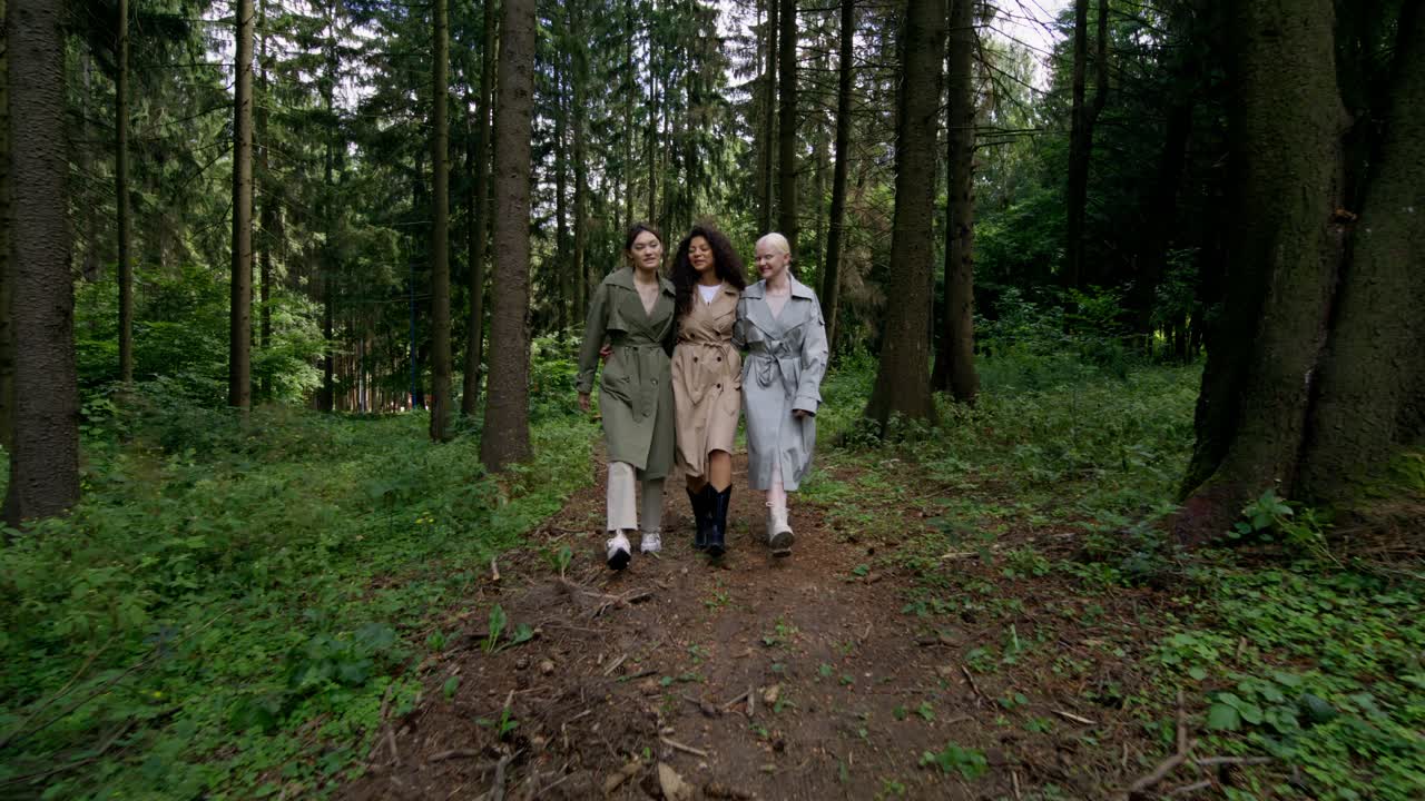 Three women walking in the forest