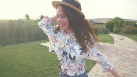 happy woman in summer clothes relaxing on a couch outdoors