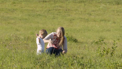 mother and son on green grass