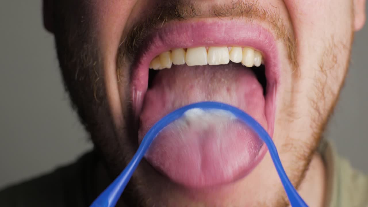 using a tongue cleaner