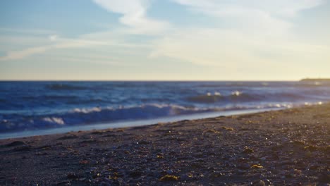 Empty-beach-with-selective-focus-from-the-sand-into-the-ocean