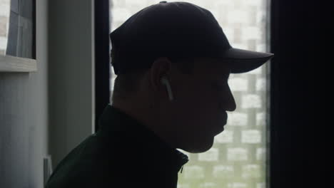 Close-up-of-a-a-exhausted-runner-drinking-water-after-workout-in-a-moody-and-backlit-scene