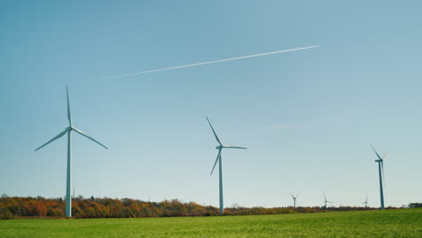 jet trail over wind turbines