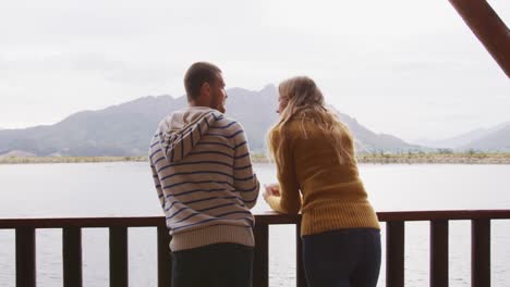 caucasian couple spending time at home together, looking at the view
