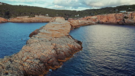 extending rock formations of punta de sa galera cove beach in san antonio, ibiza, spain