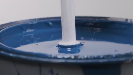 close up of plastic stick dipped in blue paint