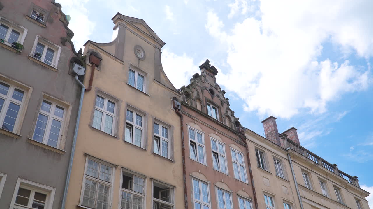 Row of traditional gabled houses in Gdansk Old Town under sunny blue sky