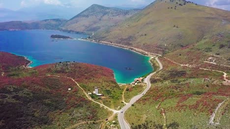 the stunning coastline and landscapes of porto palermo on the albanian riviera in eastern europe, aerial flyover