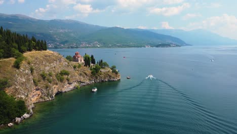 aerial view of a boat on lake ohrid north macedonia passing traditional orthodox church