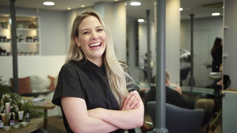 portrait of female stylist or business owner in hairdressing salon