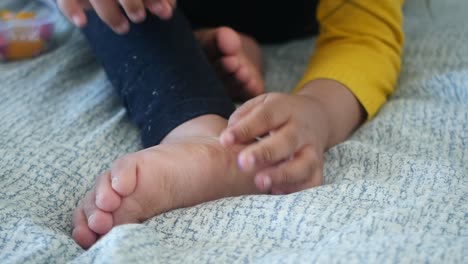 child inspecting foot