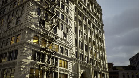 historic building featuring ornate architecture and fire escape at dusk