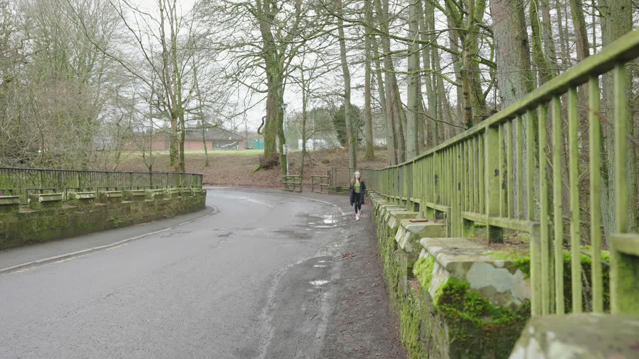 지역 공원에서 짧은 다리를 걷고 있는 어린 소녀