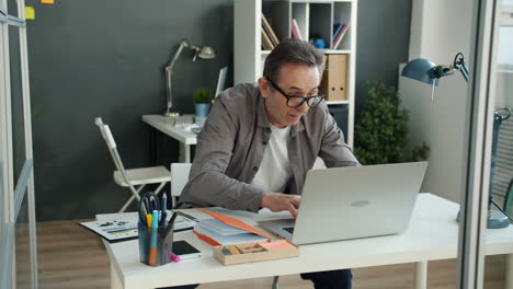 frustrated businessman working on laptop