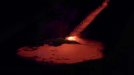 magma lava flowing down stream, forming lava lake, steming smoke and bubbles forming and boiling