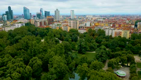 4k aerial drone video of high rise apartment buildings and modern skyscrapers near indro montanelli garden park in milan, italy (high speed)