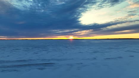 Footage-over-a-frozen-lake-at-sunset