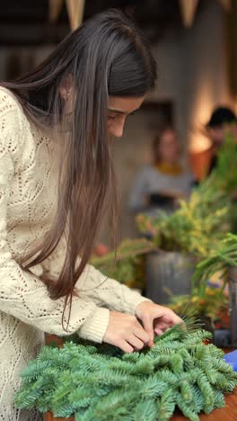 woman making a christmas wreath