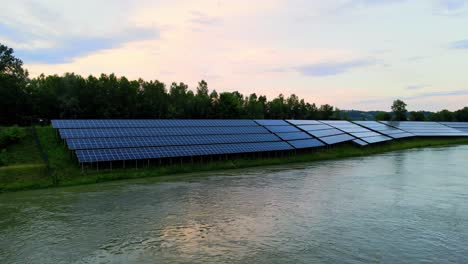 Captivating-aerial-4K-drone-footage-of-a-solar-panel-plant-nestled-alongside-the-Drava-river-in-Slovenia