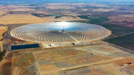 planta de energía de paneles solares fotovoltaicos. planta de energía termosolar, un centro de granja solar rodeada de campos - vista panorámica con un dron - concepto de medio ambiente