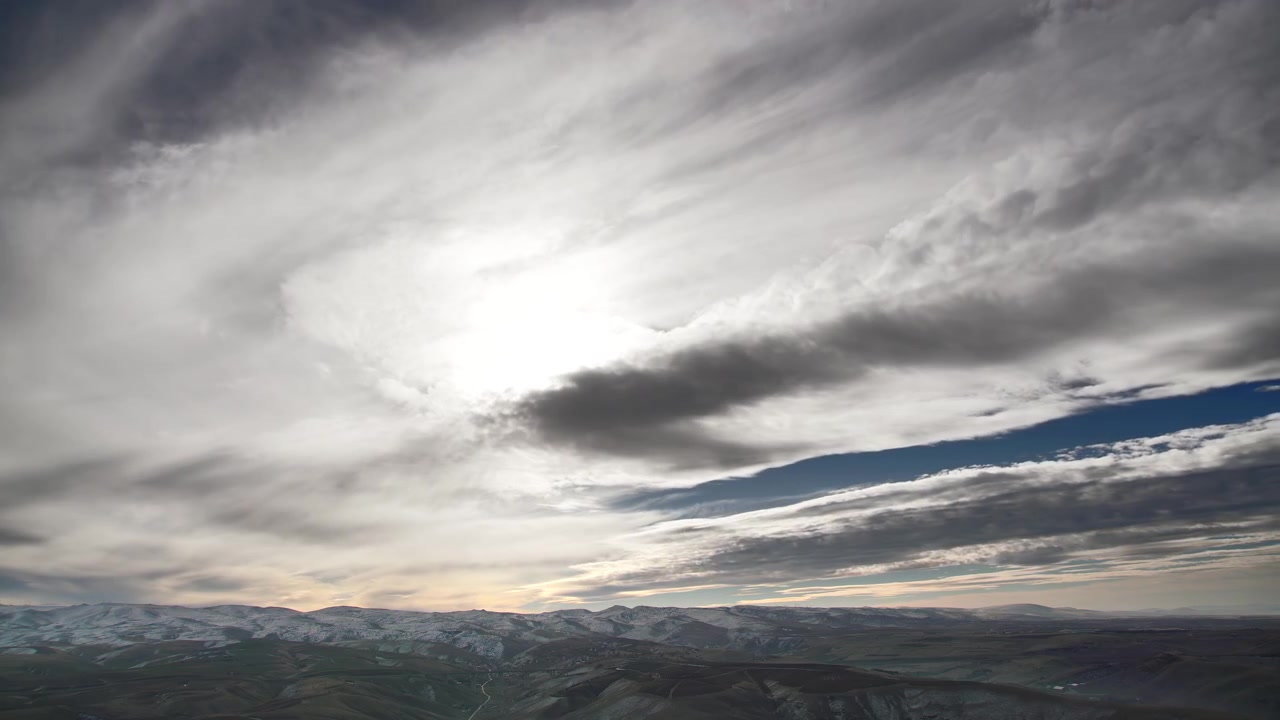 Time Lapse of Moving Clouds Over Snowy Mountain Landscape