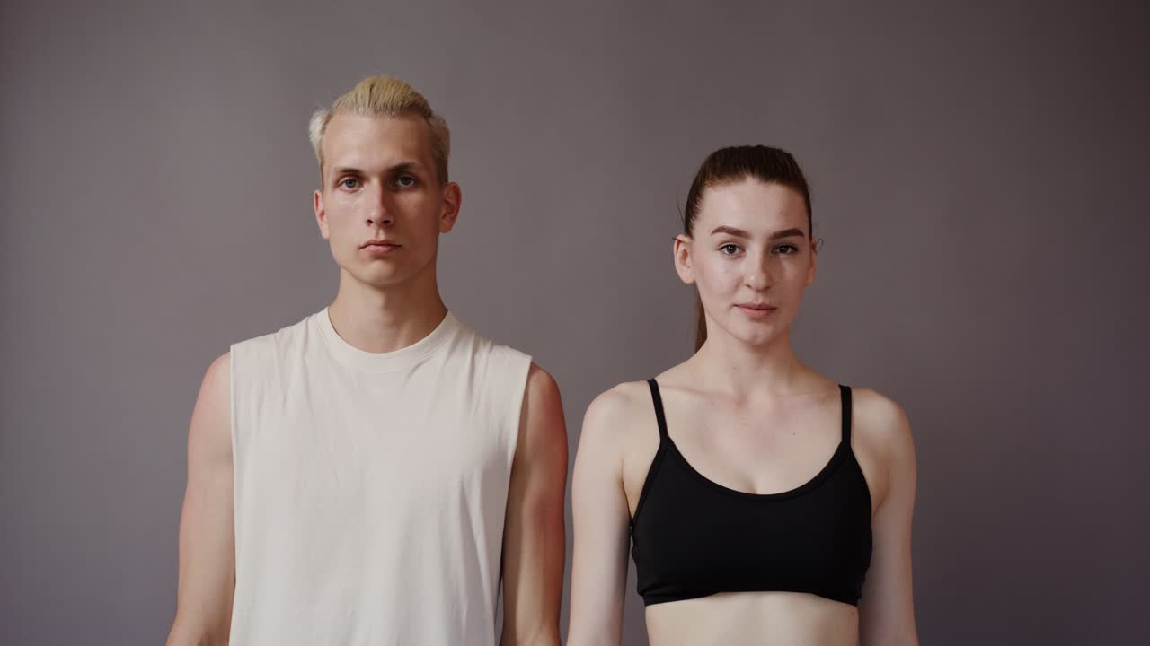 Young couple smiling at camera in a studio