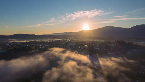 sun rising over the mountains with fog, stunning aerial view in the caribbean, morning view in a tropical country