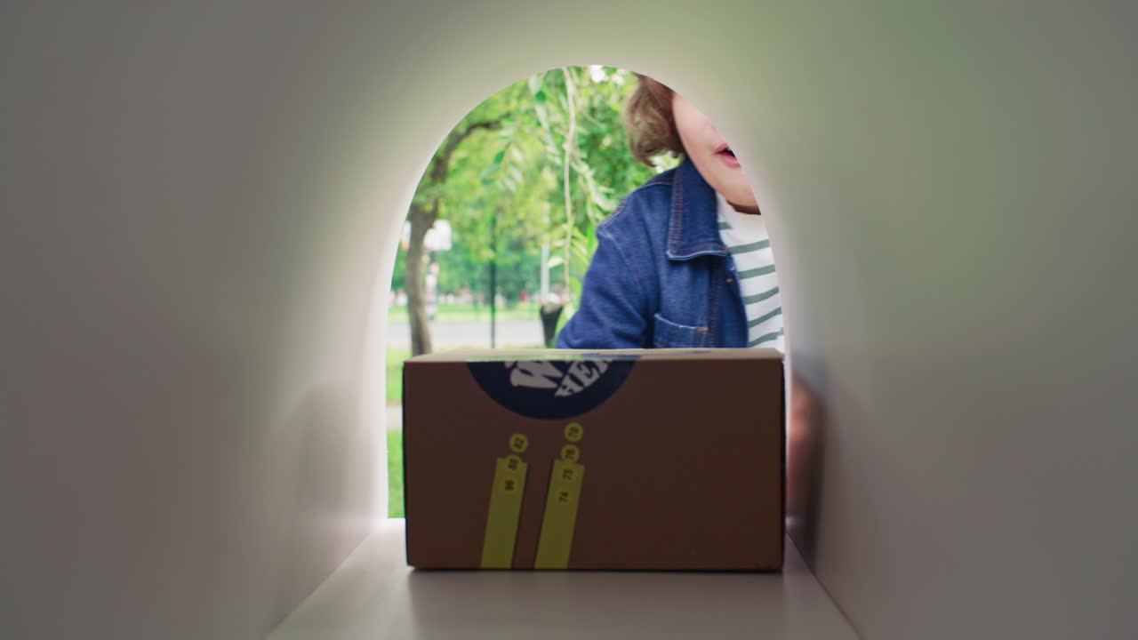 Joyful Boy Receiving Parcel from Mailbox and Jumping with Excitement