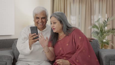 Happy-Old-Indian-couple-talking-on-video-call