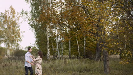 Couple-Hugging-And-Walking-On-A-Meadow-In-Summer-At-Sunset-5