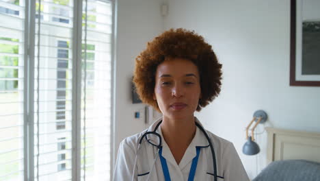 portrait of smiling female nurse wearing uniform with digital tablet in private hospital room