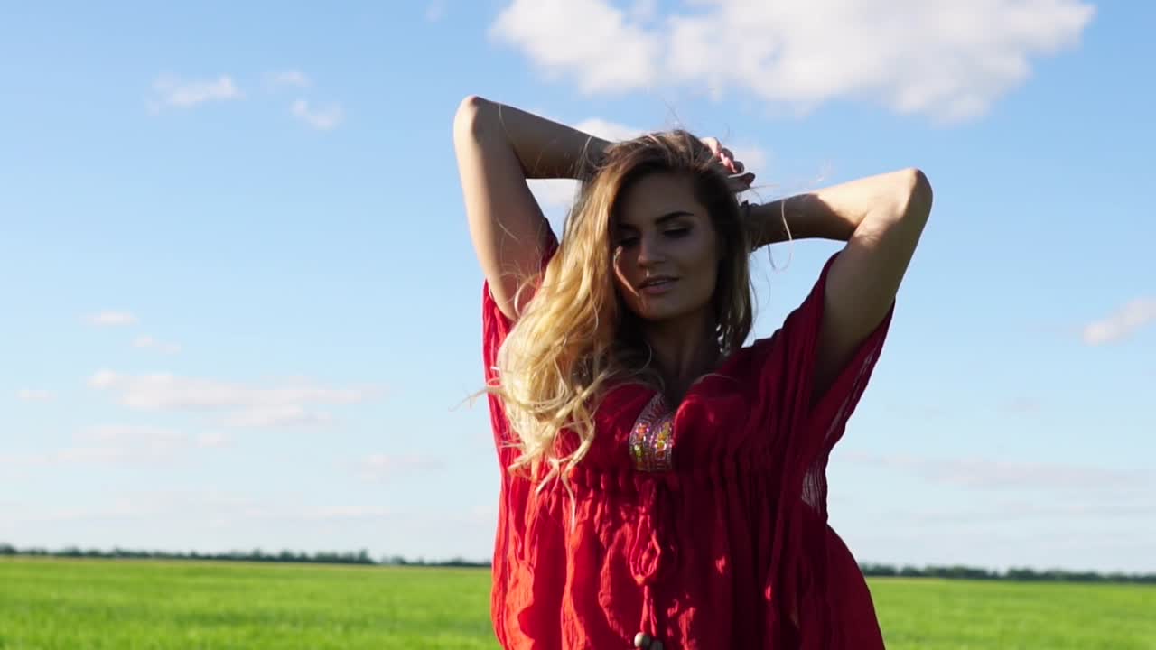 Woman in a Red Dress in a Field