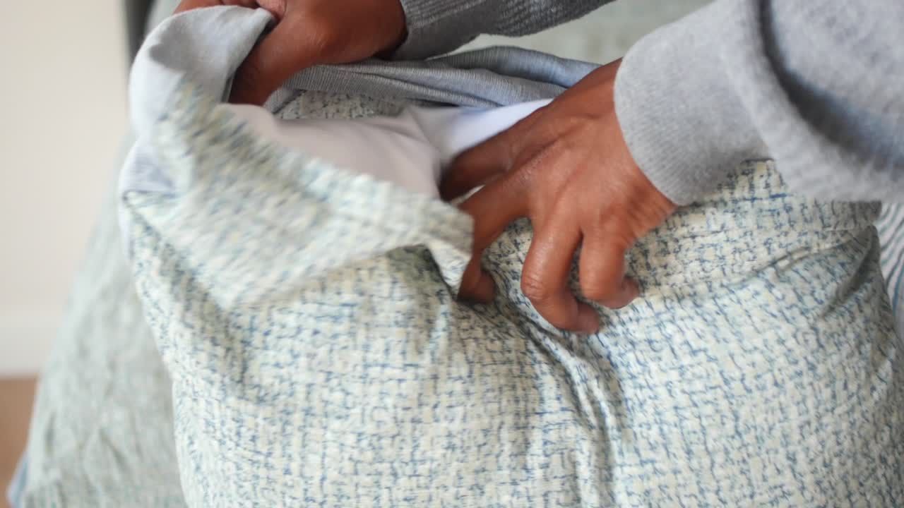 침대를 꾸미고 침대를 고 있는 사람