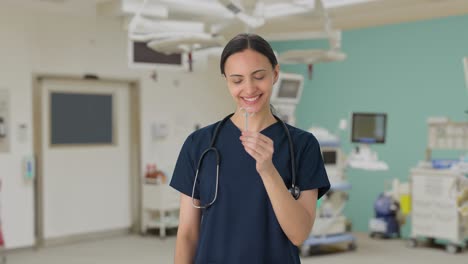 Happy-Indian-female-doctor-inspecting-surgical-instruments