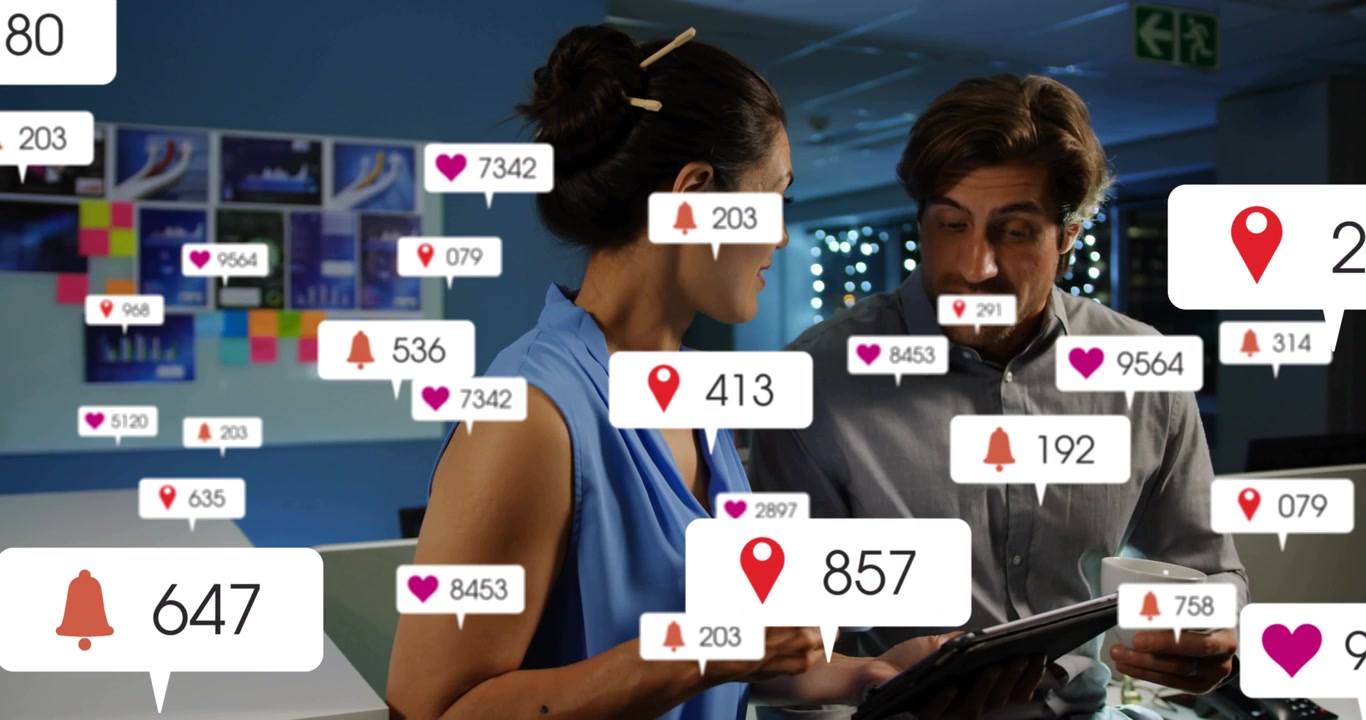 Marketing team tapping tablet in office initiating icons updating around device, reviewing metrics