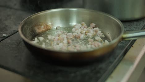 cooking bacon in a pan