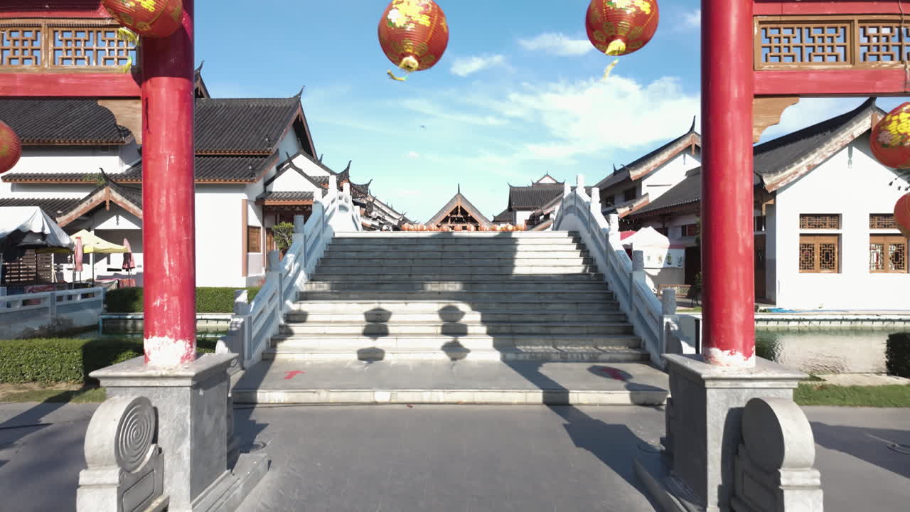 Chinese Lanterns Hanging On The Entrance Gate To Dragon Descendants Museum (Wat Mangkon, Heaven Dragon Park) in Suphan Buri, Thailand. - tilt up shot