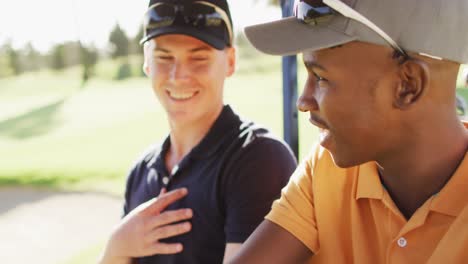 Video-of-happy-diverse-male-friends-driving-cart-on-golf-field