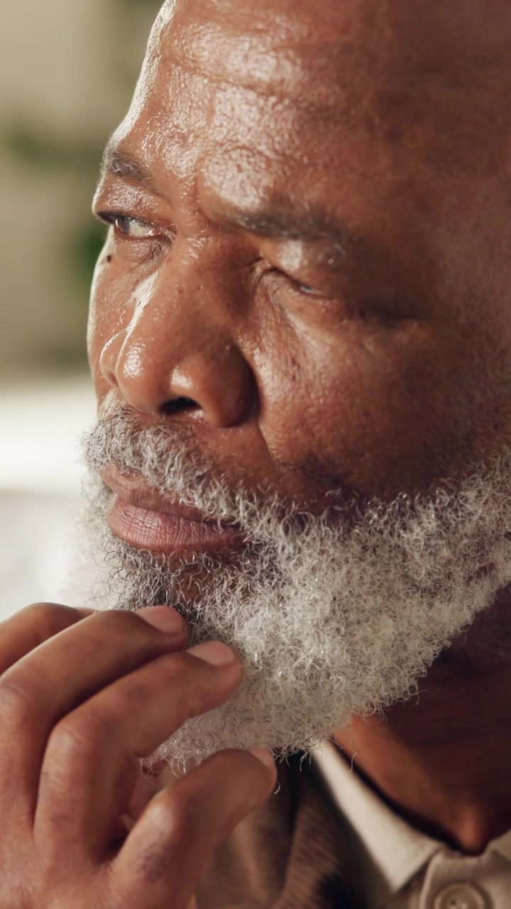 Thoughtful Senior Man Touching His Beard