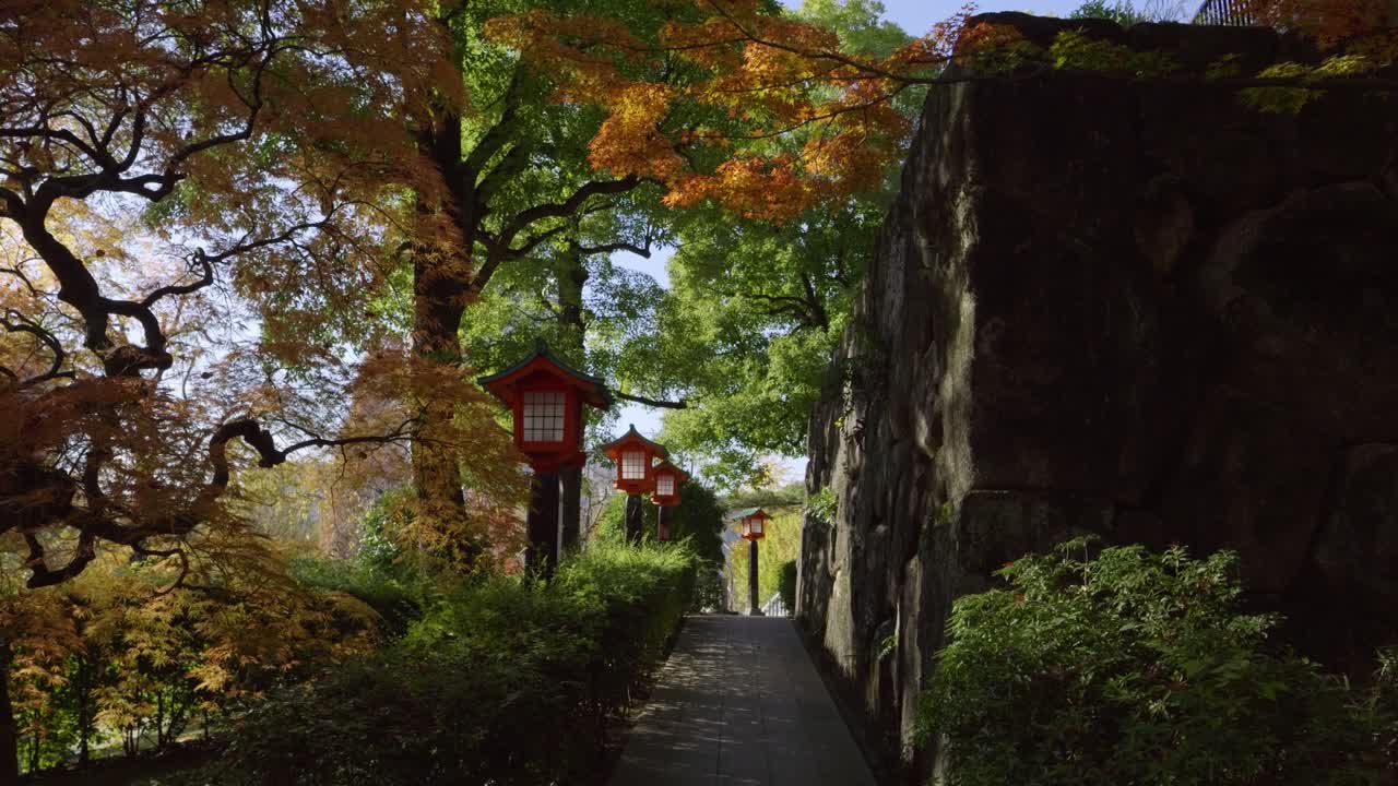 Perfect fall color scenery at Japanese temple grounds with typical lanterns