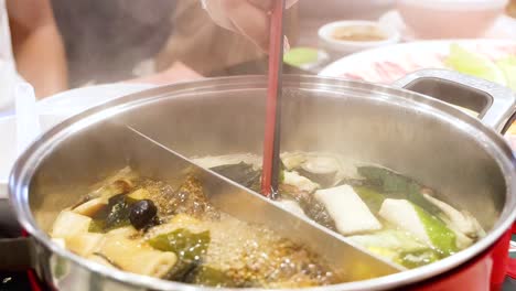 simmering hotpot with fresh ingredients in bangkok