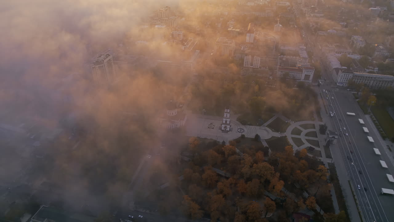 Aerial drone view of Chisinau at sunrise, Moldova. View of city centre covered with fog and low clouds. Central Park, Goverment building