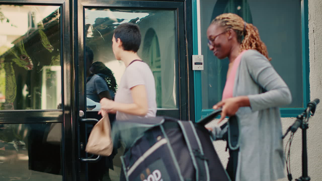 People exiting a building with a food delivery