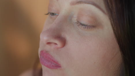 close up of woman enjoying a slice of grilled chicken pizza, with melted cheese and tender chicken pieces, capturing the satisfaction of eating a delicious, savory pizza in a cozy setting