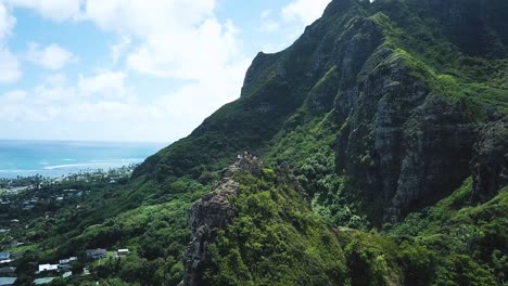 Drone-Shot-flying-away-from-a-group-of-hikers-at-the-top-peak-of-Crouching-Lion-hike-on-the-East-side-of-Oahu,-Hawaii