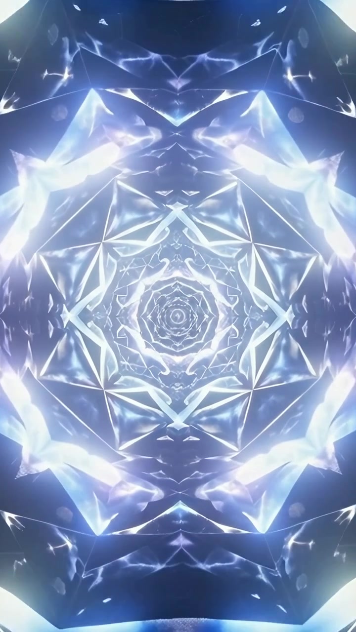 Video verticale: Mandala animato che si stringe verso l'interno in un vuoto oscuro, mostrando sfaccettature e bagliori dell'obiettivo
