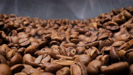 close up of seeds of coffee. fragrant coffee beans are roasted smoke comes from coffee beans.