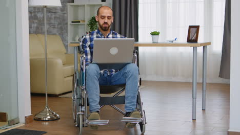 businessman in wheelchair waving