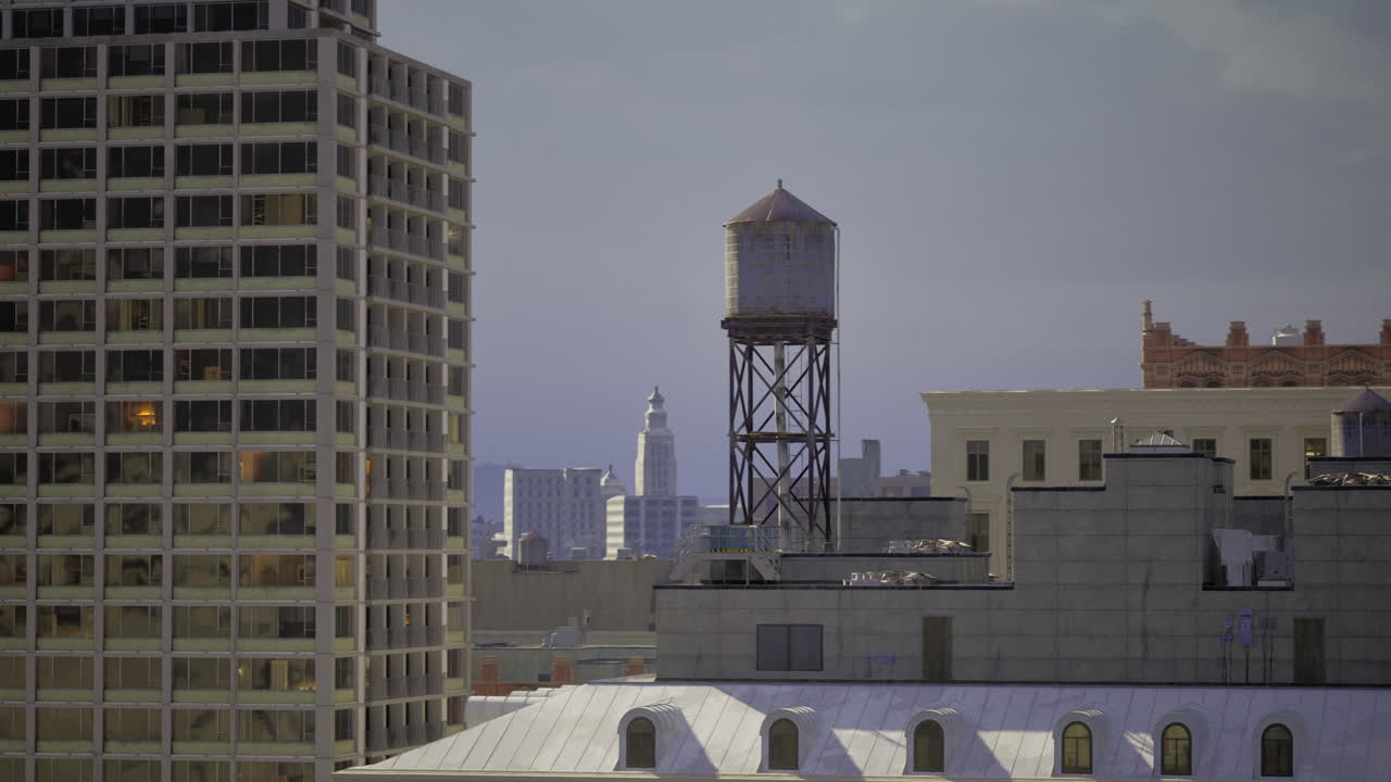 Cityscape featuring water tower with skyline in background during dusk